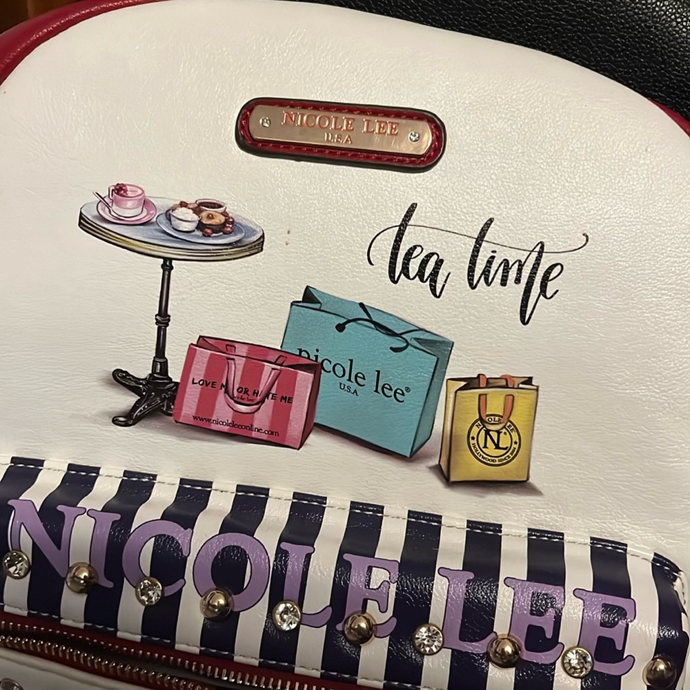 Nicole Lee rechargeable backpack with lots of small items that area